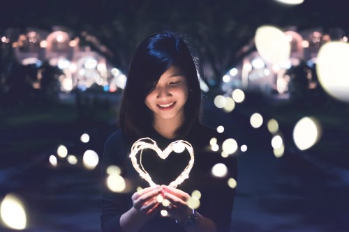 Girl with a lighted heart shape.