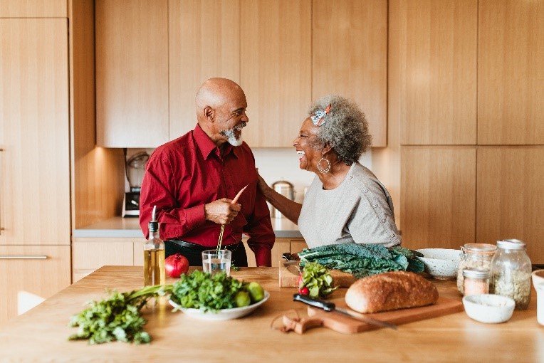 Photo of an older couple in a kitchen.